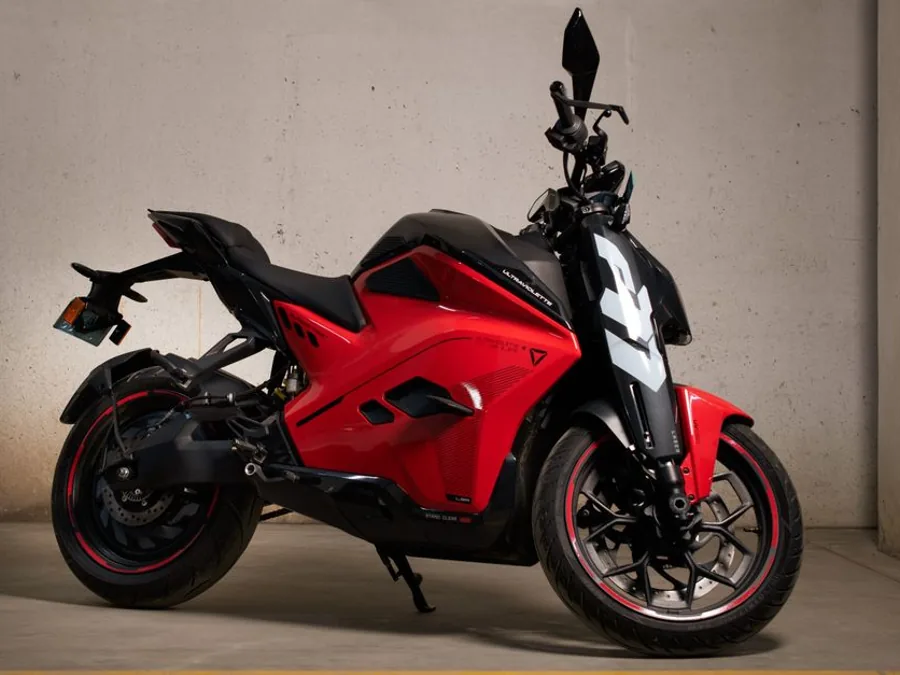Une moto garée dans un atelier, outils au mur.